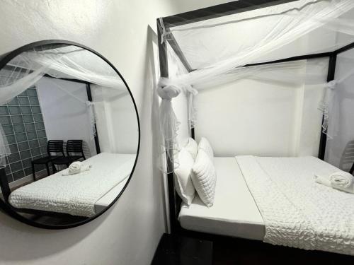 a bedroom with two bunk beds and a mirror at Mahajab Homestay SIARGAO in General Luna