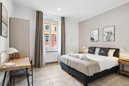 a bedroom with a bed and a desk and a window at limehome Rome via dei Reti in Rome
