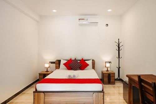 a bedroom with a large bed with red pillows at River Breeze Villa Bentota in Bentota