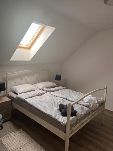 a bedroom with a bed with a skylight at Kuća za odmor “Viola” in Vukovar