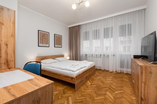 a hotel room with a bed and a television at Lewicka 8 by Homeprime in Warsaw