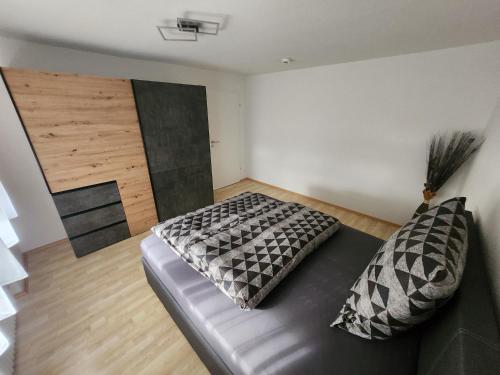 a bedroom with a couch and a wooden floor at Apartment am Südhang 2 in Dinkelsbühl