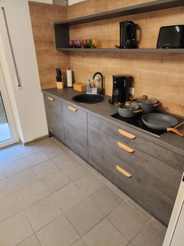 a kitchen with a counter with pots and pans on it at Apartment am Südhang 2 in Dinkelsbühl