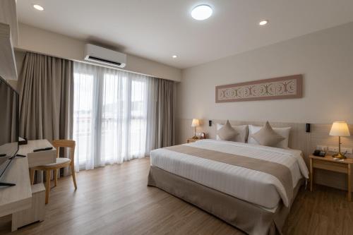 Postel nebo postele na pokoji v ubytování Kantary Hotel Banchang