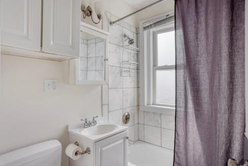 a bathroom with a sink and a toilet and a window at South Boston 3br fully furnished equipped BOS-928 in Boston