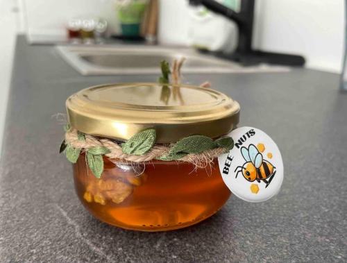 a jar of honey on a counter with a tag at Gartenparadies Ferienhaus in Singen