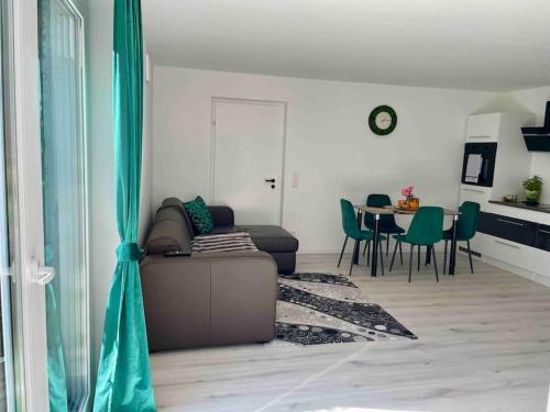 a living room with a couch and a table at Gartenparadies Ferienhaus in Singen