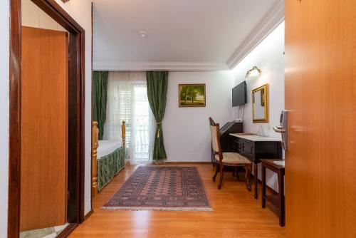 a room with a desk and a bedroom with a bed at Heritage Hotel Pasike in Trogir