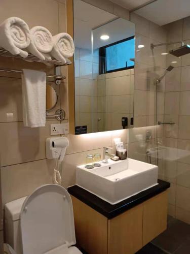 a bathroom with a sink and a toilet and a mirror at G-Luxe By Gloria Genting Highlands in Genting Highlands