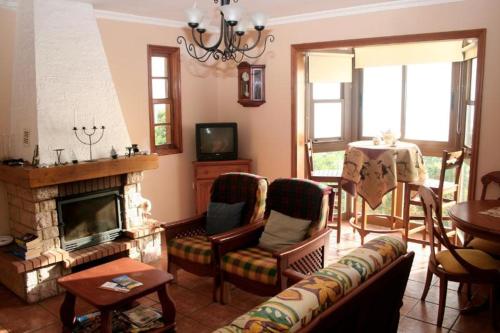 a living room with a couch and a fireplace at Casa Sabela con vistas al MAR in Arecida