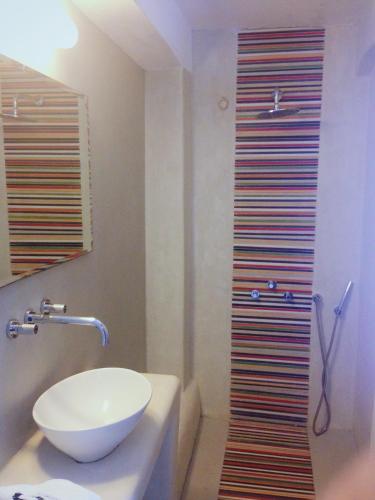 a bathroom with a sink and a shower at Altana Cliffside Villas in Imerovigli