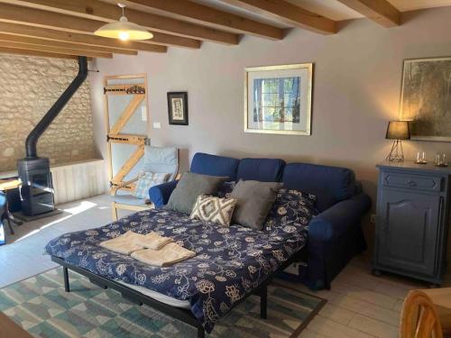 a living room with a blue couch in a room at Stunning rural gem with pool in southwest France in Brie-sous-Barbezieux