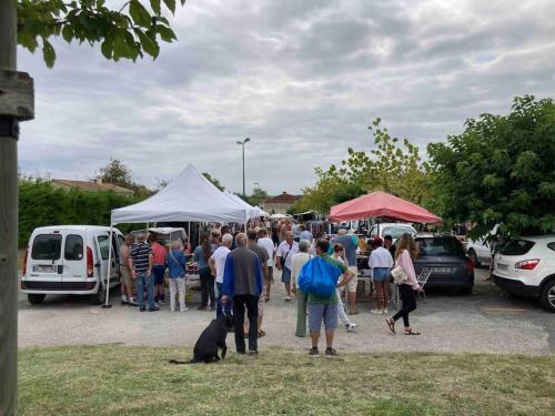 a crowd of people walking around a parking lot at Stunning rural gem with pool in southwest France in Brie-sous-Barbezieux