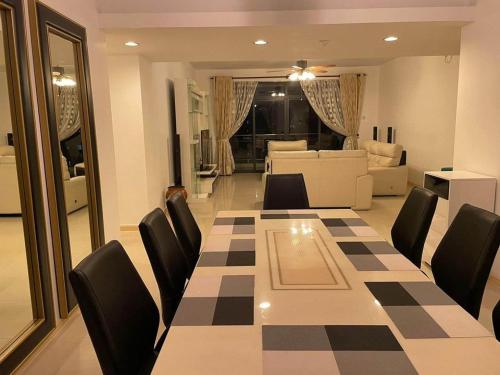 a dining room with a table and chairs and a living room at Luxury Apartment in Kaduwela