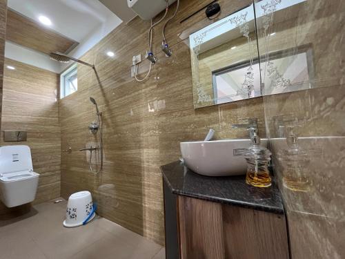 a bathroom with a sink and a toilet at Bahar Retreat And Spa , Gangtok in Gangtok