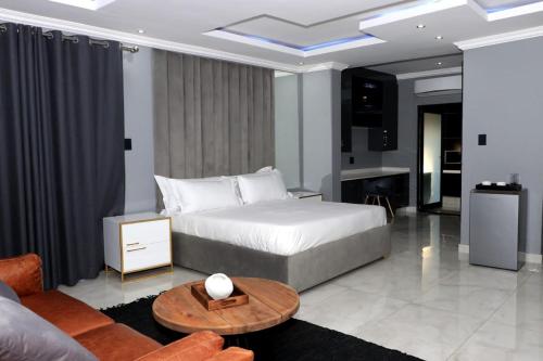 a bedroom with a bed and a living room at The Residence Villa in Musina