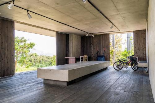 a large room with a bench in the middle of it at HOTEL E-horizon Resort コンドミニアム瀬底 in Motobu