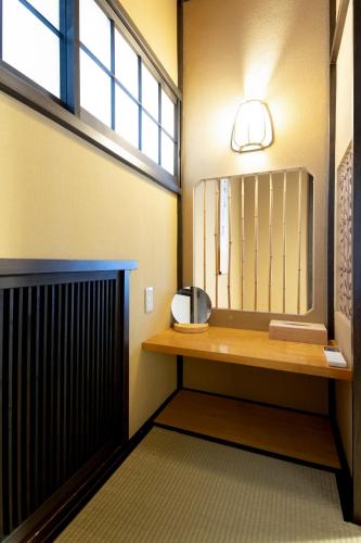 a bathroom with a sink and a mirror at Hakone Sengokuhara Soubokuan 箱根仙石原 相睦菴 in Sengokuhara