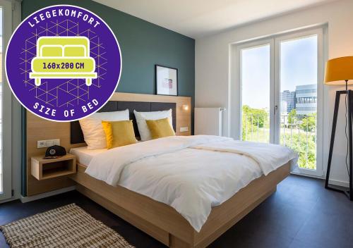a bedroom with a large bed with a purple sign at KONCEPT HOTEL Neue Horizonte in Tübingen