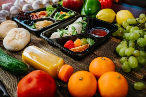 un tavolo sormontato da vassoi di frutta e verdura diverse di Apartments Centre by Arrenda a Varsavia