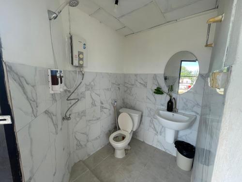 a bathroom with a toilet and a sink at Budget Accommodation Koh Phangan Pier in Ko Phangan