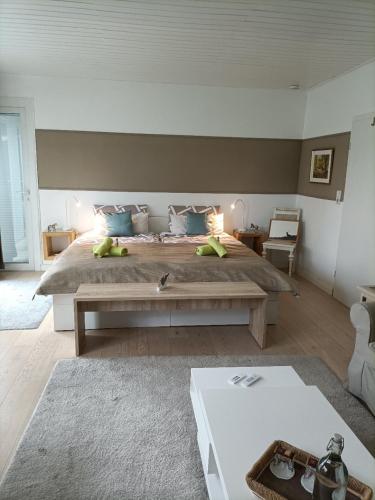 a large bedroom with a large bed and a table at Haus Tourneur in Lippetal