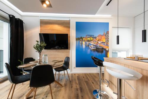 una sala da pranzo con un grande dipinto di un porto di Apartament River Towers a Bydgoszcz