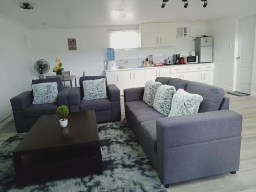 a living room with two couches and a coffee table at Lopez Beach Resort in Sipalay