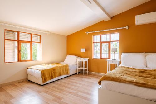 a bedroom with two beds and two windows at Nature View Flat w Terrace 5 min to Beach in Kemer in Antalya