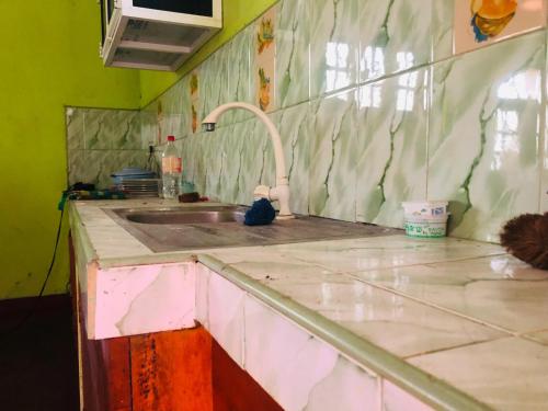 a kitchen with a sink and a counter top at MarvelMansion hostel in Galle