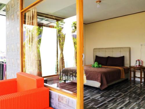 a bedroom with a bed and a large mirror at Dajan Buyan Homestay in Bedugul