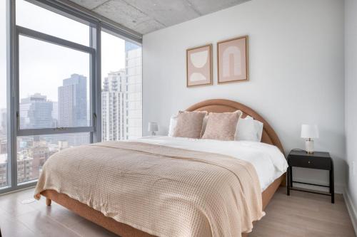 a white bedroom with a large bed and large windows at River North 1br w gym pool roof nr Riverwalk CHI-825 in Chicago