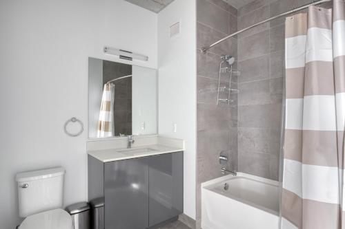 a bathroom with a shower and a sink and a toilet at River North 1br w gym pool roof nr Riverwalk CHI-825 in Chicago