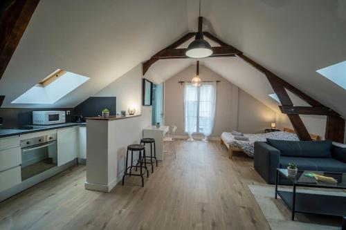 un salon avec un canapé bleu et une cuisine dans l'établissement Le Refuge Palois, à Pau