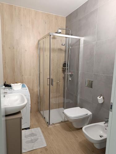 a bathroom with a shower and a toilet and a sink at Eden house in Lecco