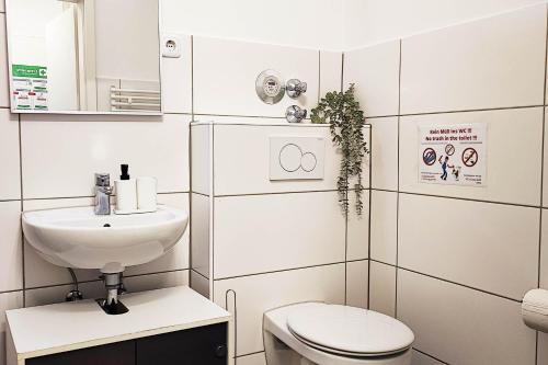 a small bathroom with a toilet and a sink at Apartment with Balcony in Mühlheim am Main in Muhlheim am Main