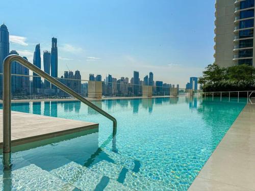 a swimming pool with a view of the city at HiGuests - Emaar Beachfront Haven with Majestic Marina Views in Dubai