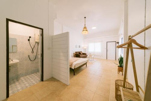 a bathroom with a shower and a sink in a room at Homely Home Khao lak in Khao Lak