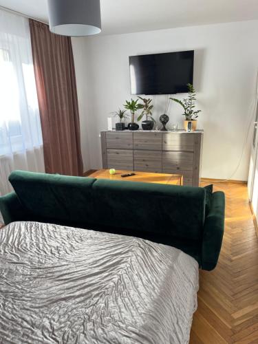 ein Schlafzimmer mit einem Bett und einem TV auf einer Kommode in der Unterkunft Apartament centrum in Szczytno