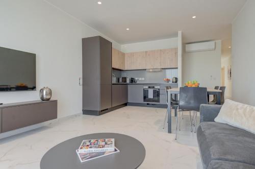 a living room with a couch and a table at Mayfair by Premier Suites MT in Is-Swieqi