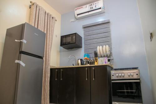 a kitchen with a refrigerator and a stove at Lake Luxury Homes in Ibadan