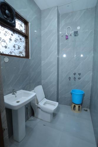 a bathroom with a sink and a toilet and a shower at Raghav inn in Karnal