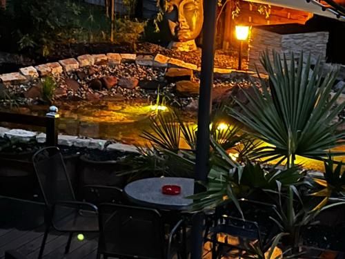 a table and chairs in a garden at night at Residenz Royal in Sandhausen