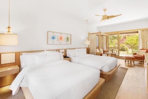 a bedroom with two beds and a living room at The Westin Sohna Resort & Spa in Gurgaon