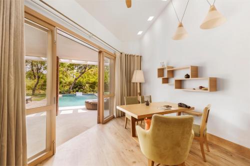 a home office with a desk and a table and chairs at The Westin Sohna Resort & Spa in Gurgaon