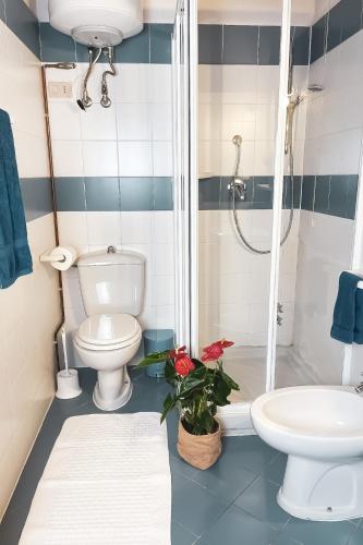 a bathroom with a toilet and a sink and a shower at Sogno - Villa Cenami - grande PISCINA con vista in Massarosa