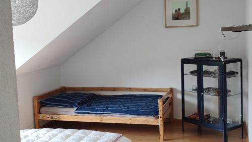 a bedroom with a bed and a black shelf at Haus Castellblick 3 in Ballrechten-Dottingen