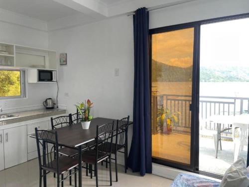 a kitchen and dining room with a table and chairs at Lopez Beach Resort in Sipalay