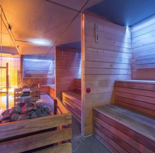 a sauna with wooden walls and benches in a room at L57_resort in Gródek Nad Dunajcem