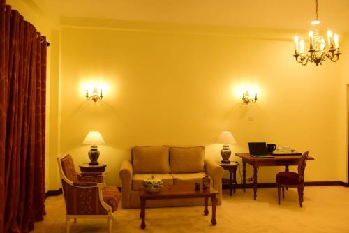 a living room with a couch and a table at Samsara in Galle